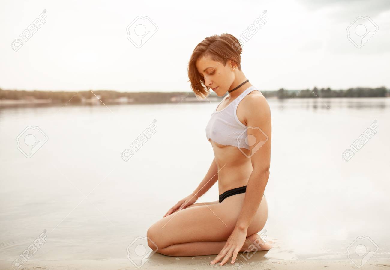 Summer Beautiful Girl With A Short Haircut On The Beach Sexy Woman With Perfect Sporty Figure In Black Swimming Trunks And Short Tank Top Athletic