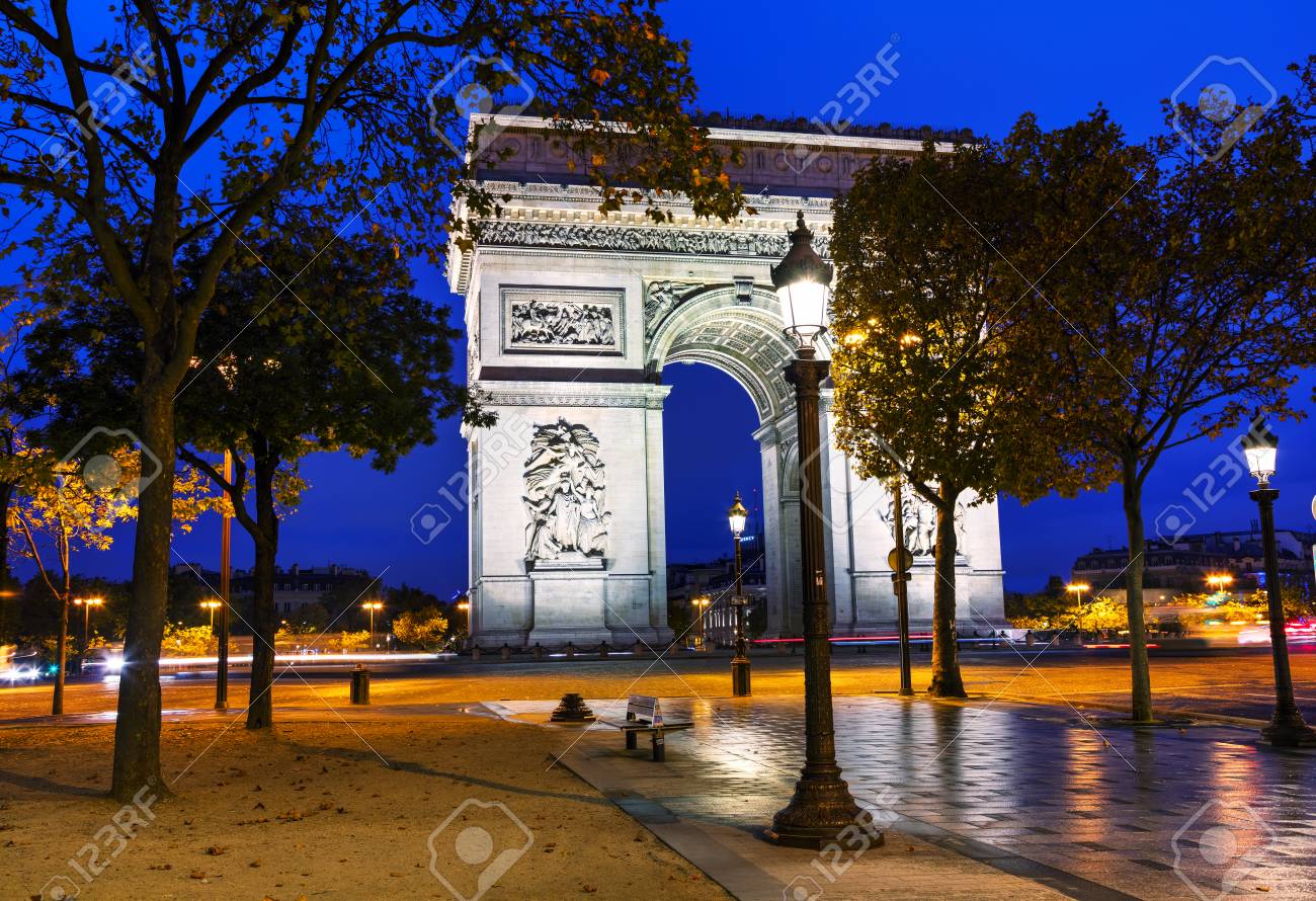 the triumphal arch arc de triomphe in paris france at night stock