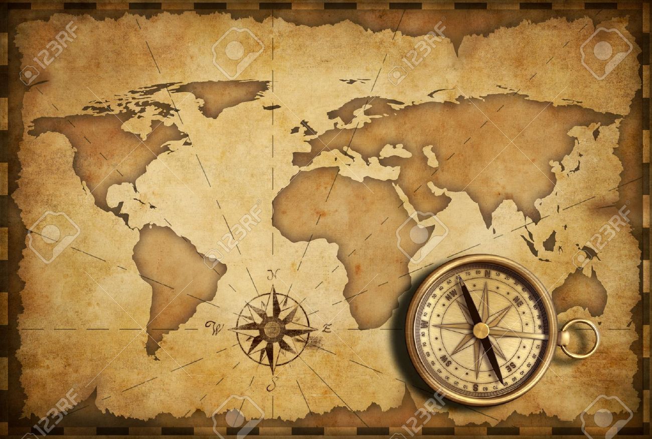 aged brass antique nautical pocket compass with old map stock photo