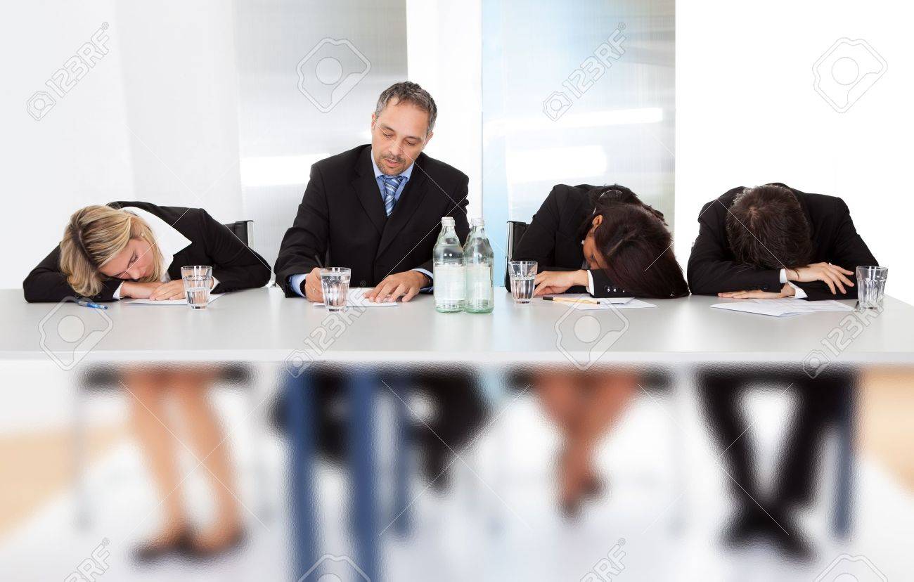 group of business people sleeping at the meeting stock photo