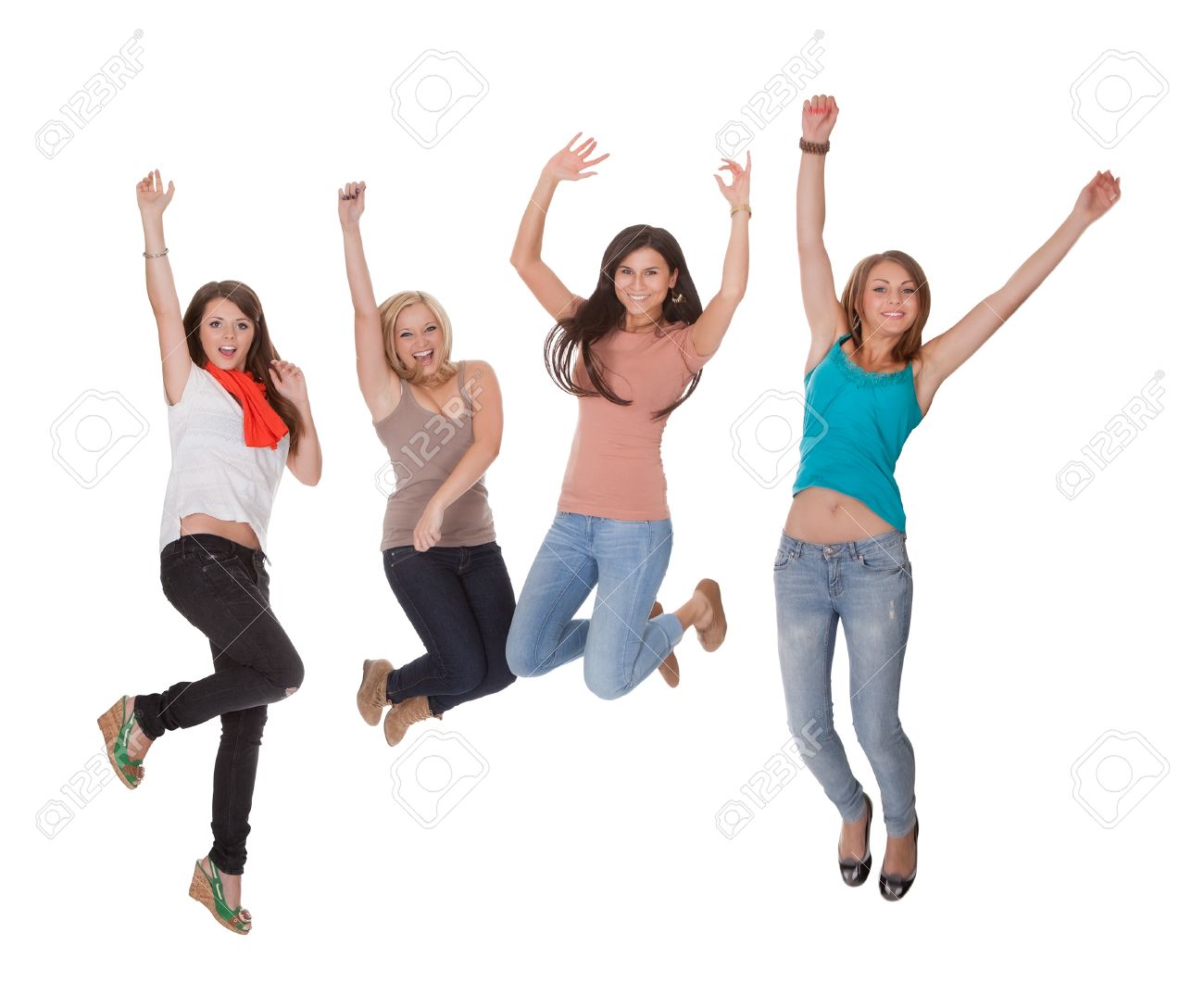 four excited young woman jumping for joy with their hands raised