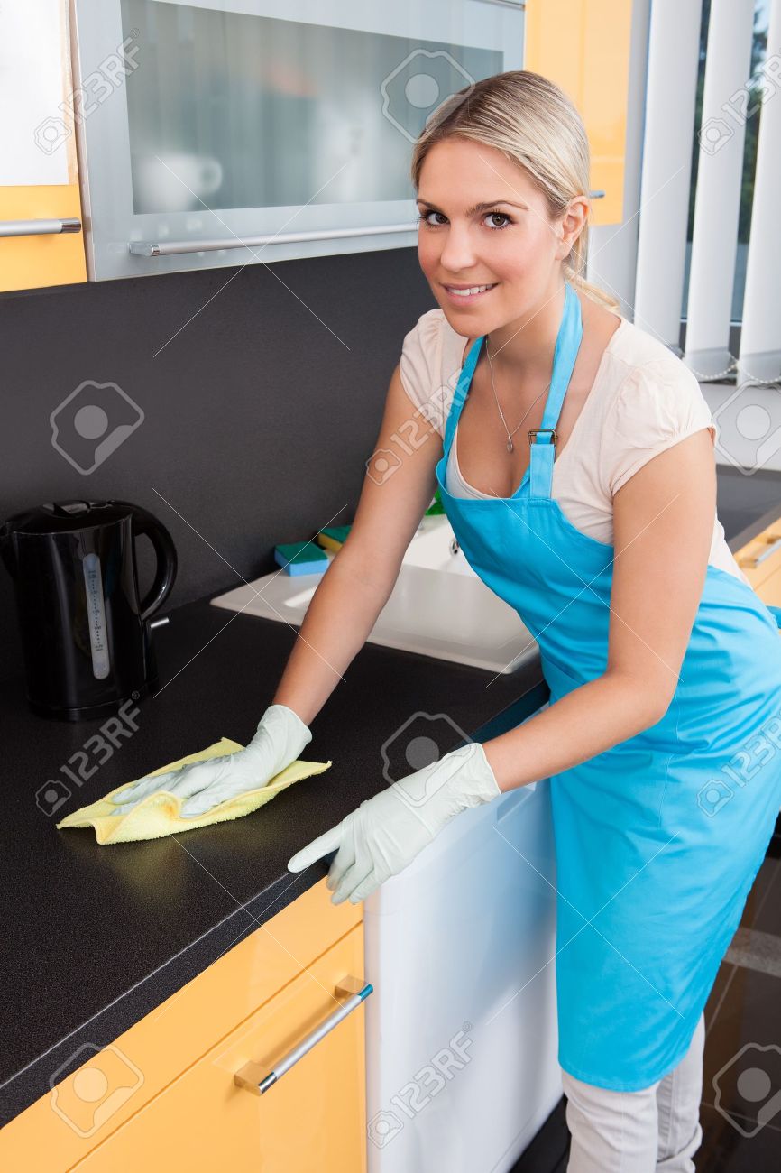 Portrait Of Happy Woman Cleaning Kitchen Worktop - 21231303 Portrait Of Happy Woman Cleaning Kitchen Worktop - 21231303