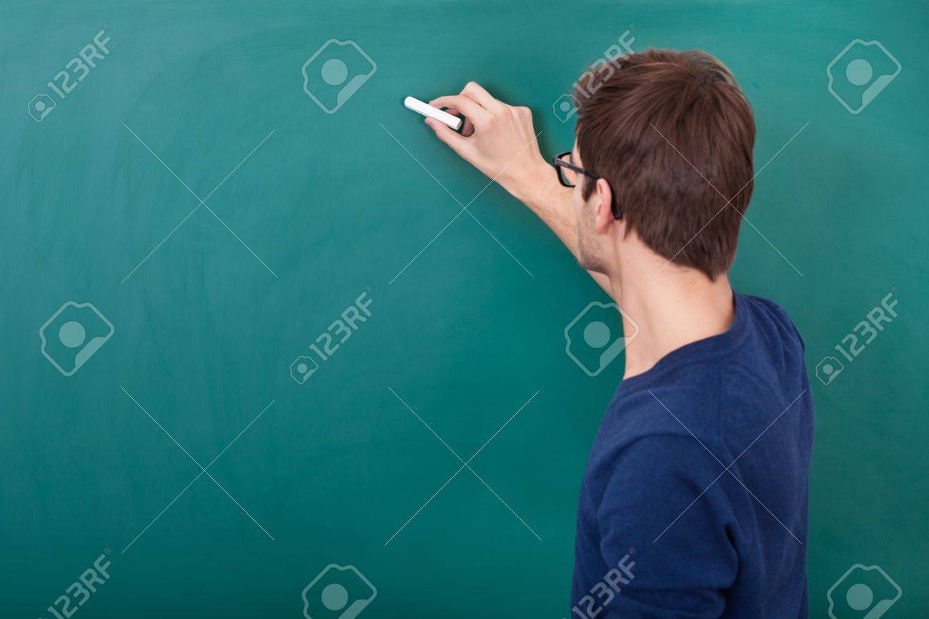 Rear View Of A Male Student Writing On Chalkboard With Chalk Stock ...