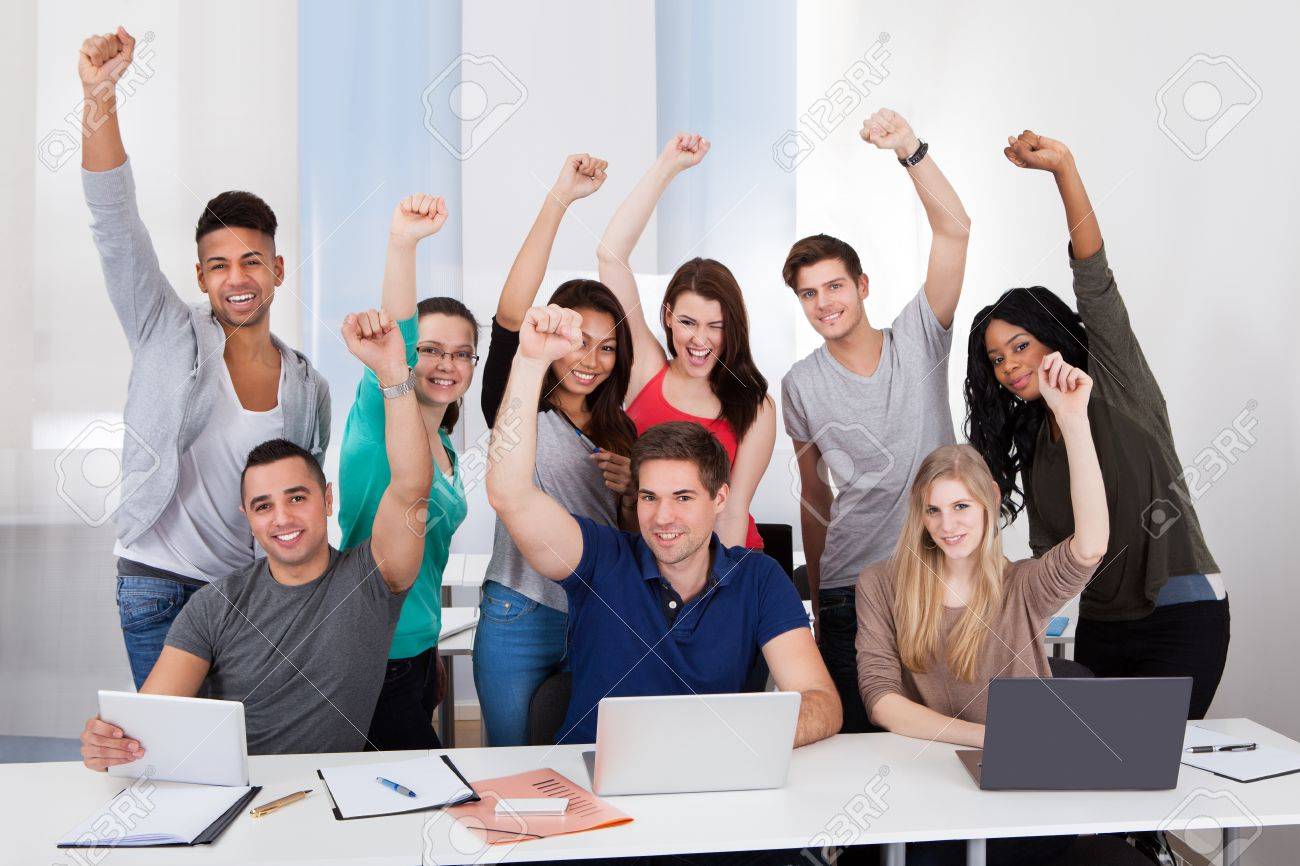 group portrait of happy multiethnic college students celebrating