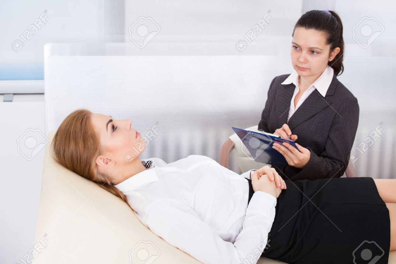 Young Female Psychiatrist Holding Clipboard Examining Businesswoman