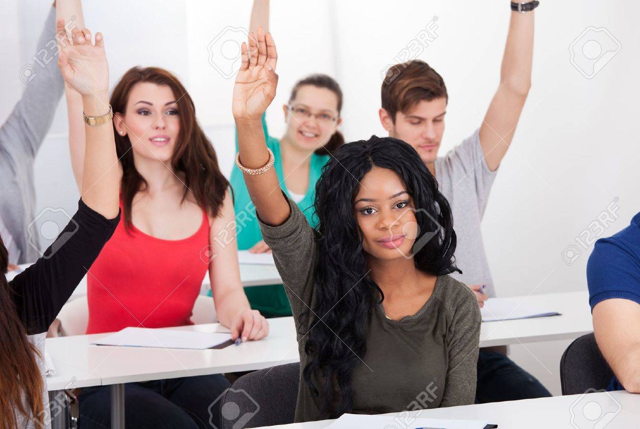 Portrait Of Female College Student Answering Question With Raised Hand In  Classroom Stock Photo, Picture and Royalty Free Image. Image 27393998., image size:1300x872