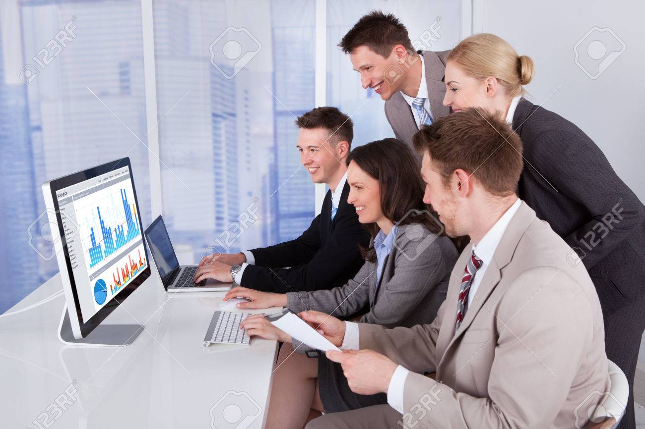 Group Of Young Business People Using Computer And Laptop In Office Stock  Photo, Picture and Royalty Free Image. Image 29532617.