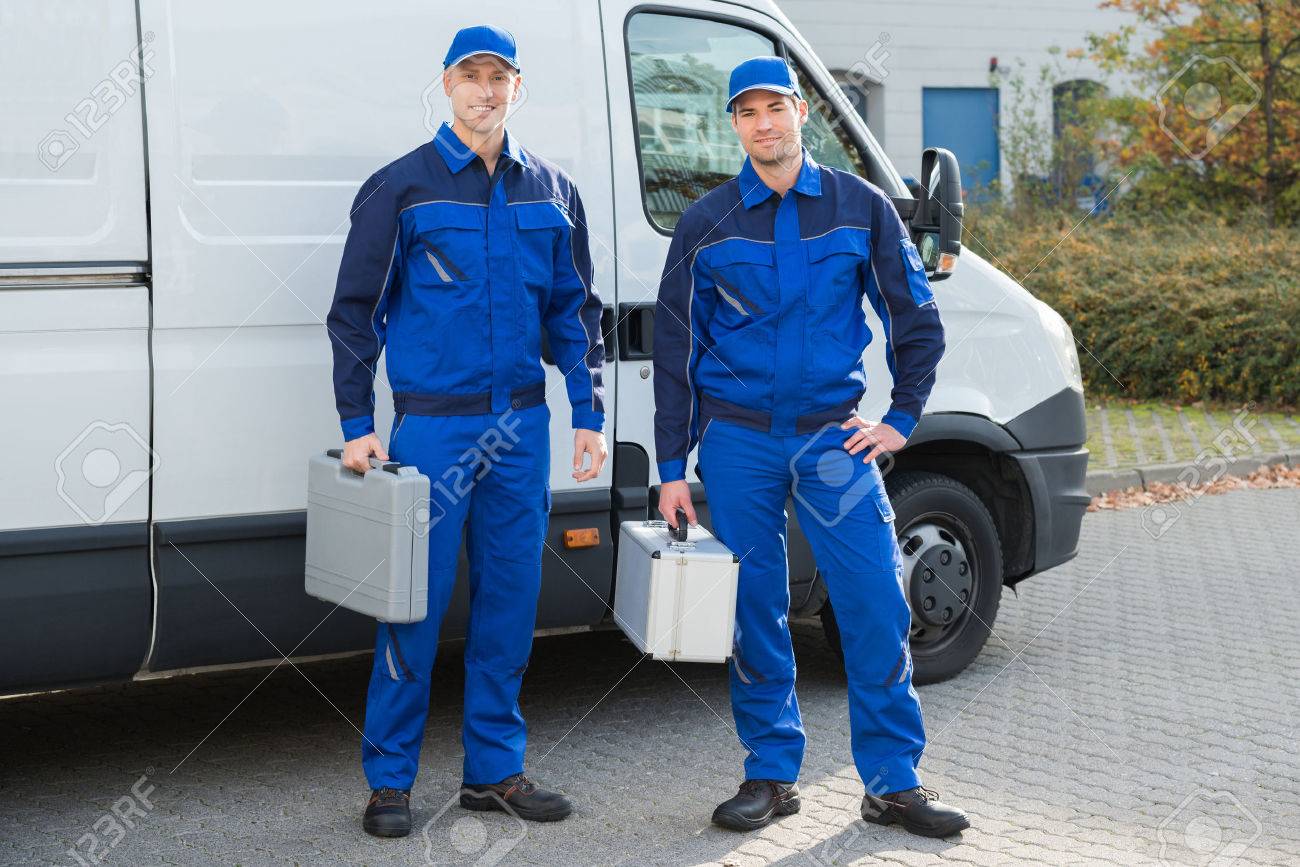 Full length portrait of confident technicians standing against truck on street - 51450673 Full length portrait of confident technicians standing against truck on street - 51450673