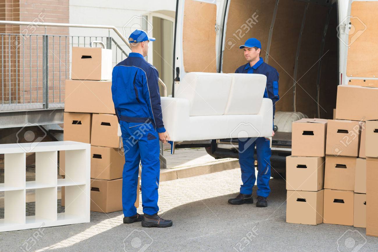 Full length of young male movers carrying sofa outside truck on street - 51450760 Full length of young male movers carrying sofa outside truck on street - 51450760
