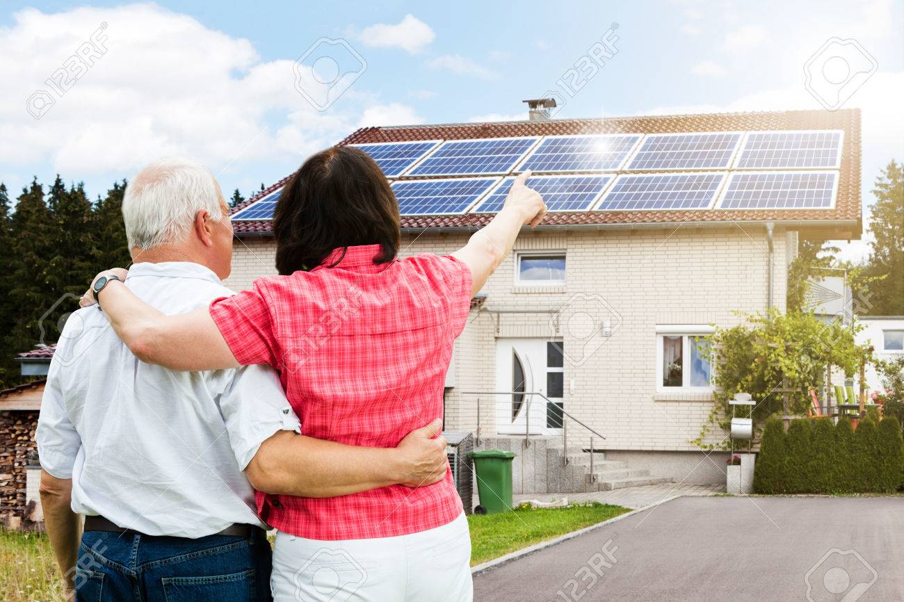 Rear View Of Senior Couple Pointing Finger In Front Of House - 64951109 Rear View Of Senior Couple Pointing Finger In Front Of House - 64951109