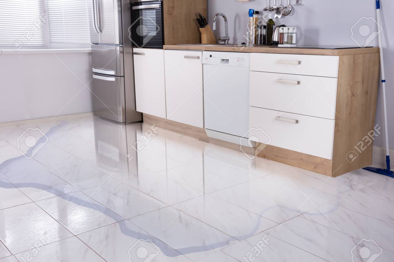 Close Up Photo Of Flooded Floor In Kitchen From Water Leak Stock