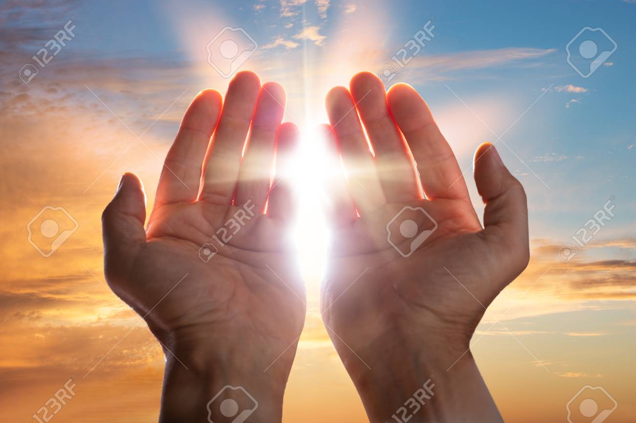 Close-up Of A Praying Hands With Sunlight - 107215996 Close-up Of A Praying Hands With Sunlight - 107215996