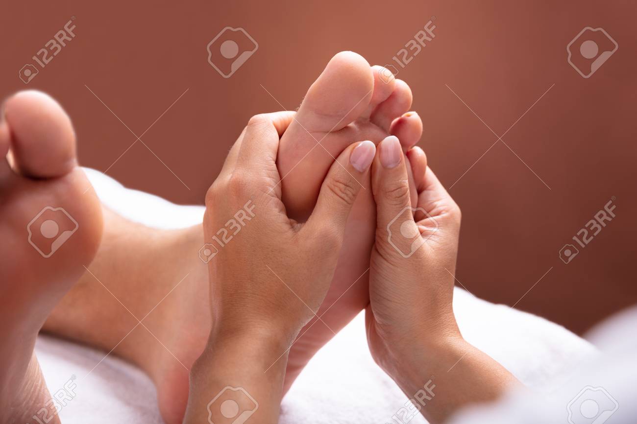 Close-up Of Therapist Hand Giving Foot Massage To Man - 113242169 Close-up Of Therapist Hand Giving Foot Massage To Man - 113242169