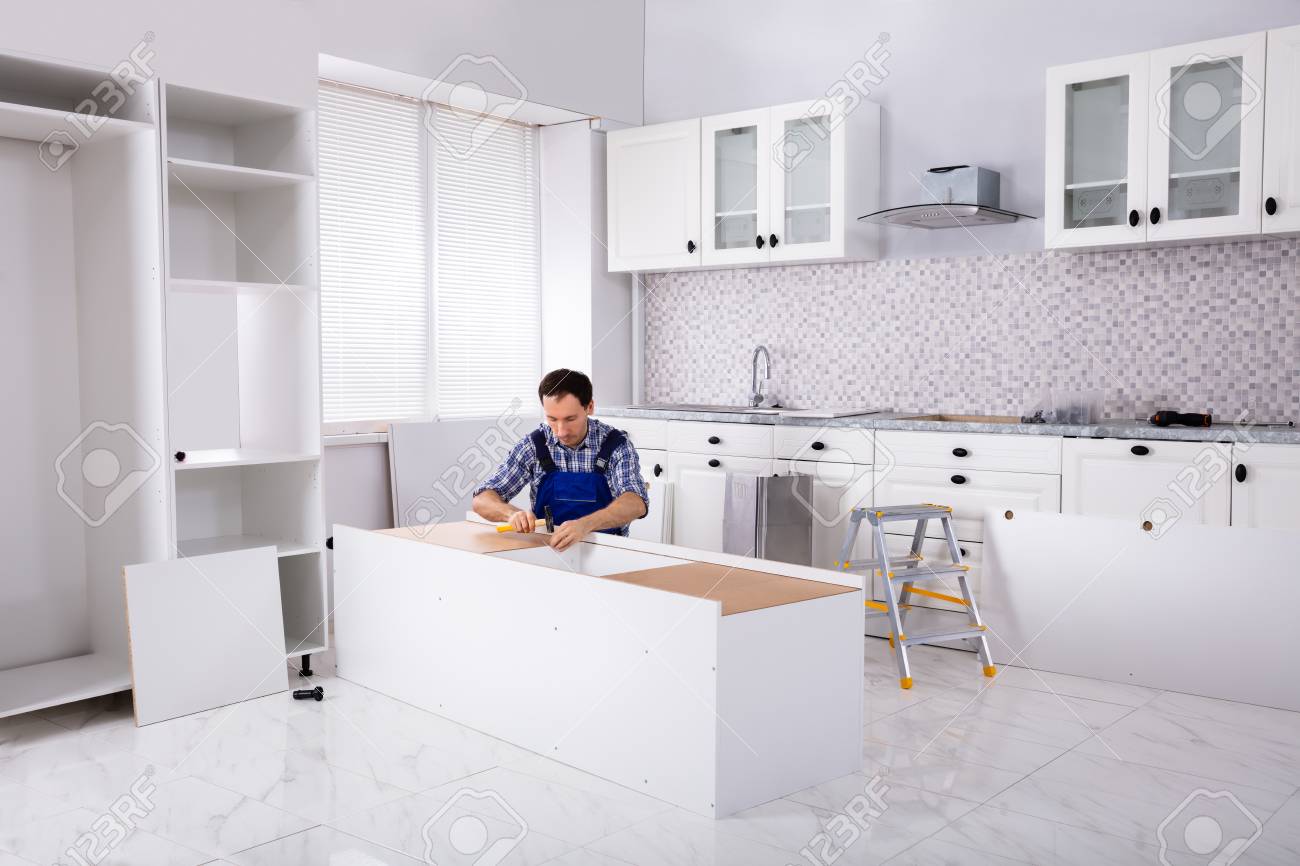 Carpenter Repair And Assembling Furniture In The Modular Kitchen