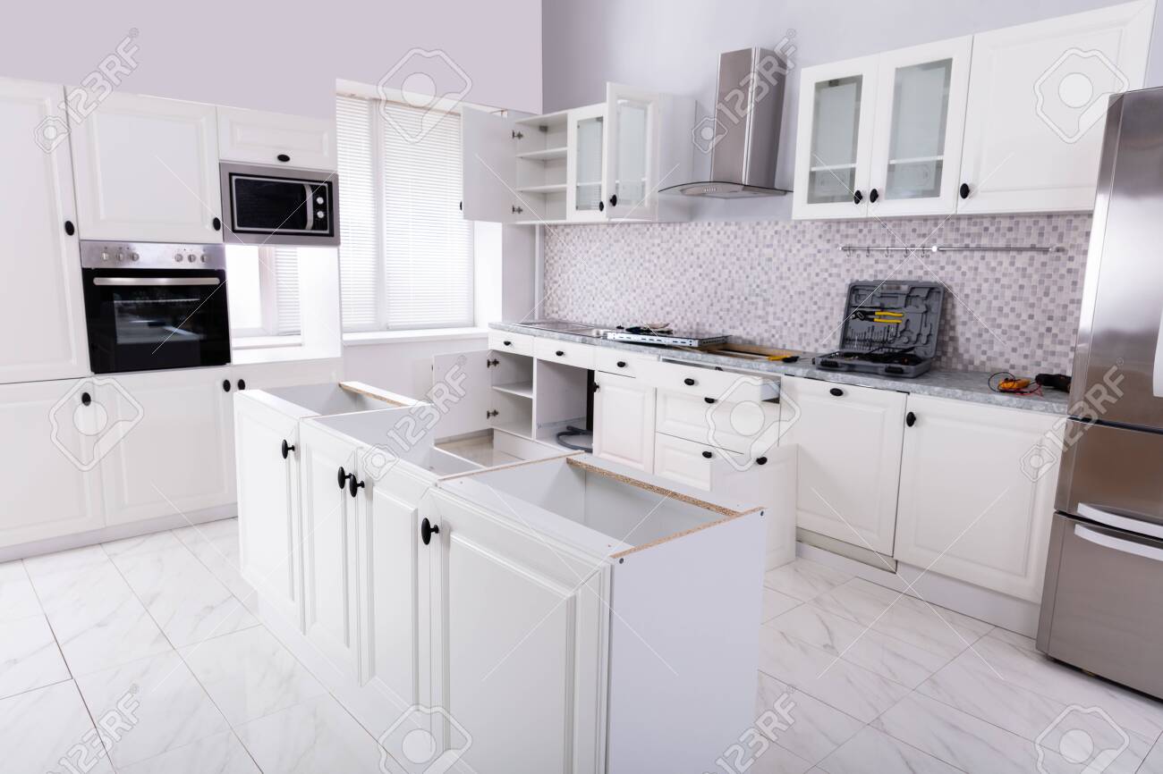 Installation Of Wooden Cabinets In The White Clean Modular Kitchen Stock Photo Picture And Royalty Free Image Image 125322580