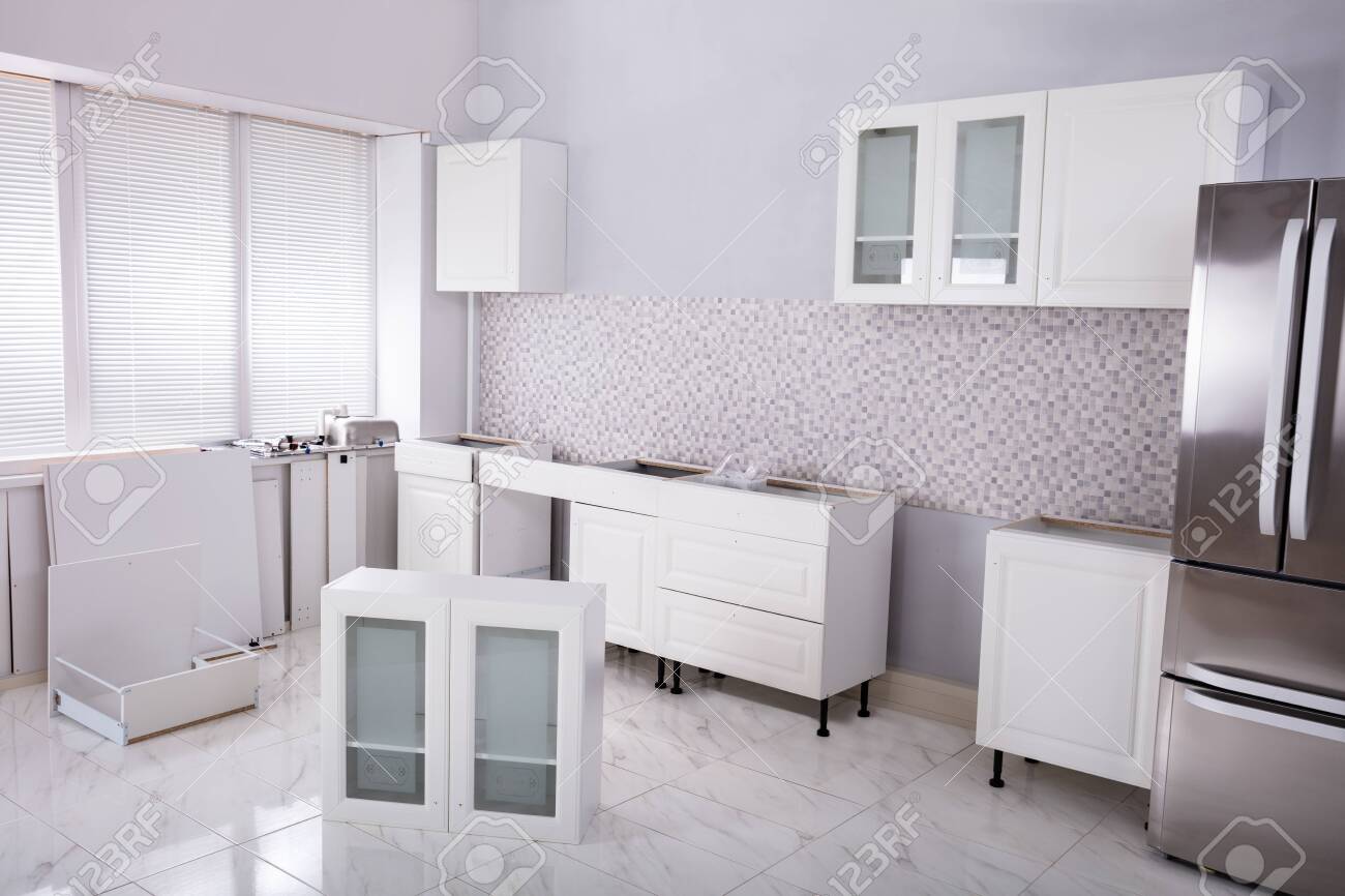 Installation Of Wooden Cabinets In The White Clean Modular Kitchen Stock Photo Picture And Royalty Free Image Image 125323041