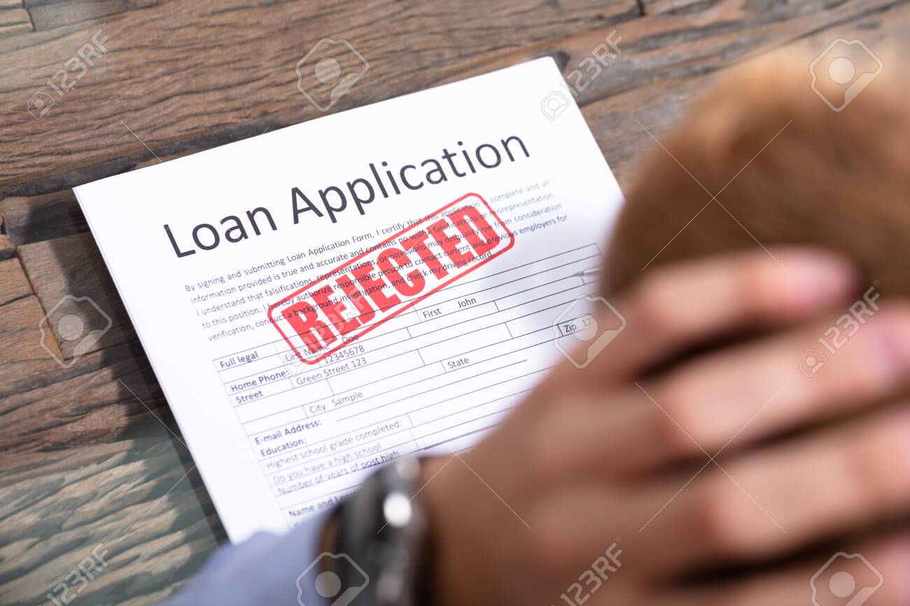 Stressed Person Looking At Rejected Loan Application - 129802598 Stressed Person Looking At Rejected Loan Application - 129802598