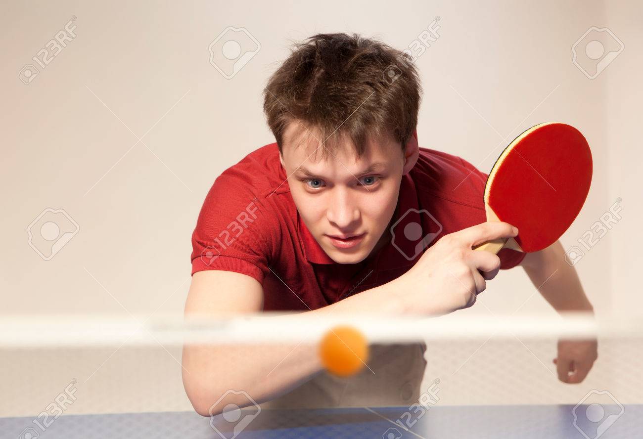 Young man playing table tennis - 52625911 Young man playing table tennis - 52625911
