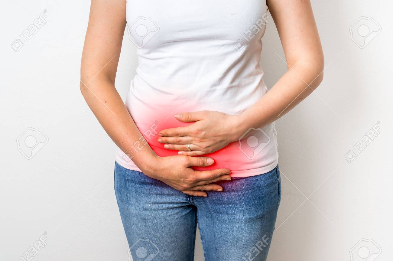Woman with menstrual pain is holding her aching belly - body pain concept - 73374096 Woman with menstrual pain is holding her aching belly - body pain concept - 73374096