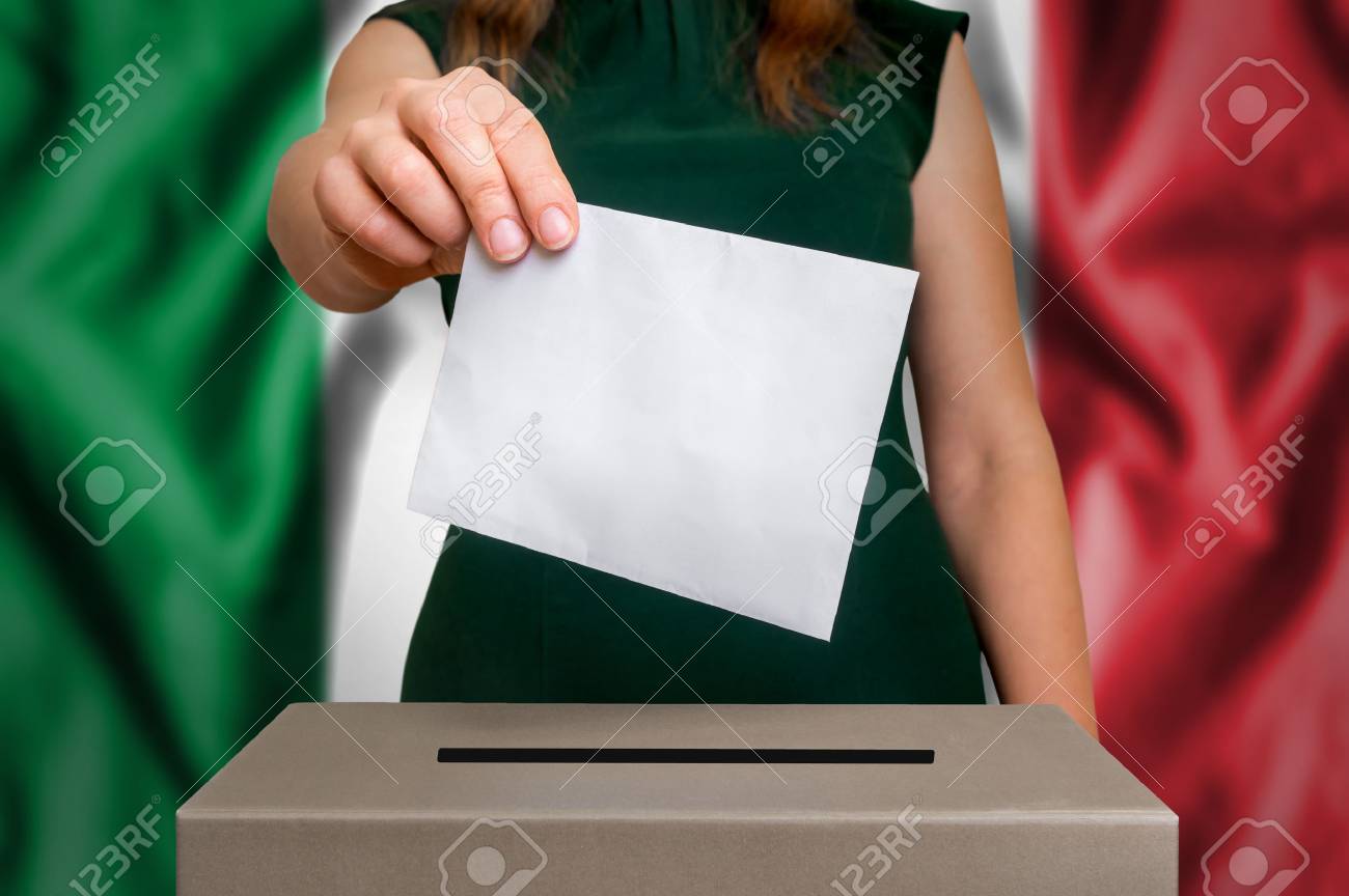 Election in Italy - voting at the ballot box. The hand of woman putting her vote in the ballot box. Flag of Italy on background. - 88075288 Election in Italy - voting at the ballot box. The hand of woman putting her vote in the ballot box. Flag of Italy on background. - 88075288