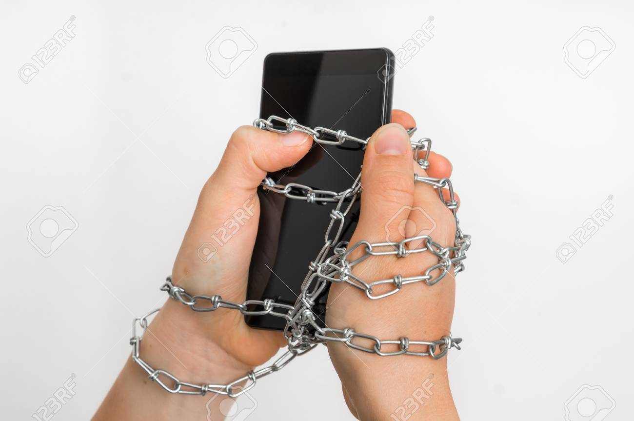 鉄チェーン関係手とスマート フォン 携帯電話中毒の概念を一緒に の写真素材 画像素材 Image