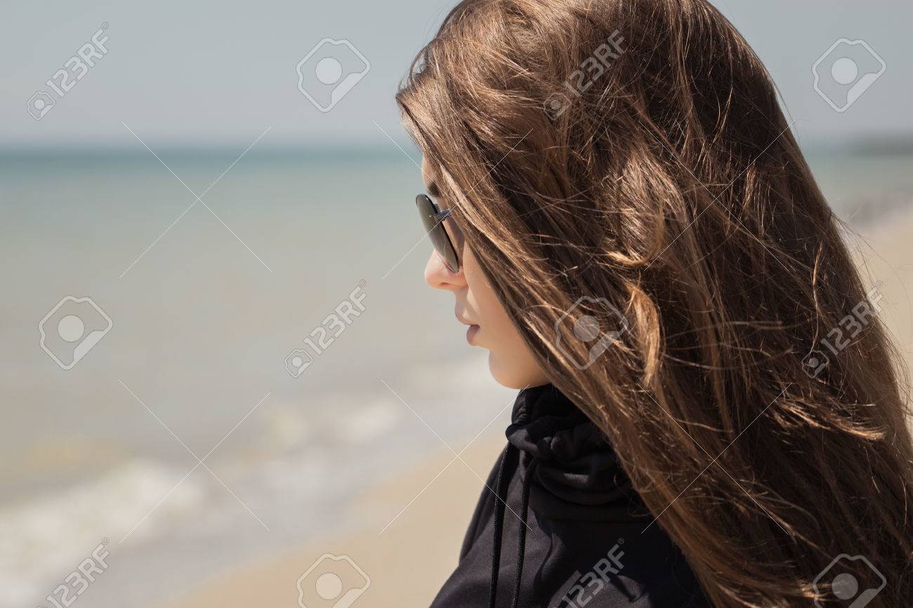 Portrait In Profile Of A Pretty Teenage Girl With Long Hair And