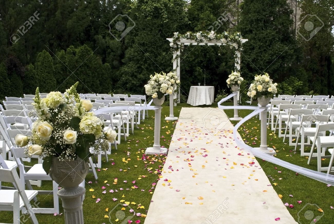 a white wedding carpet covered in rose petals and the scene of a white wedding carpet covered in rose petals and the scene of