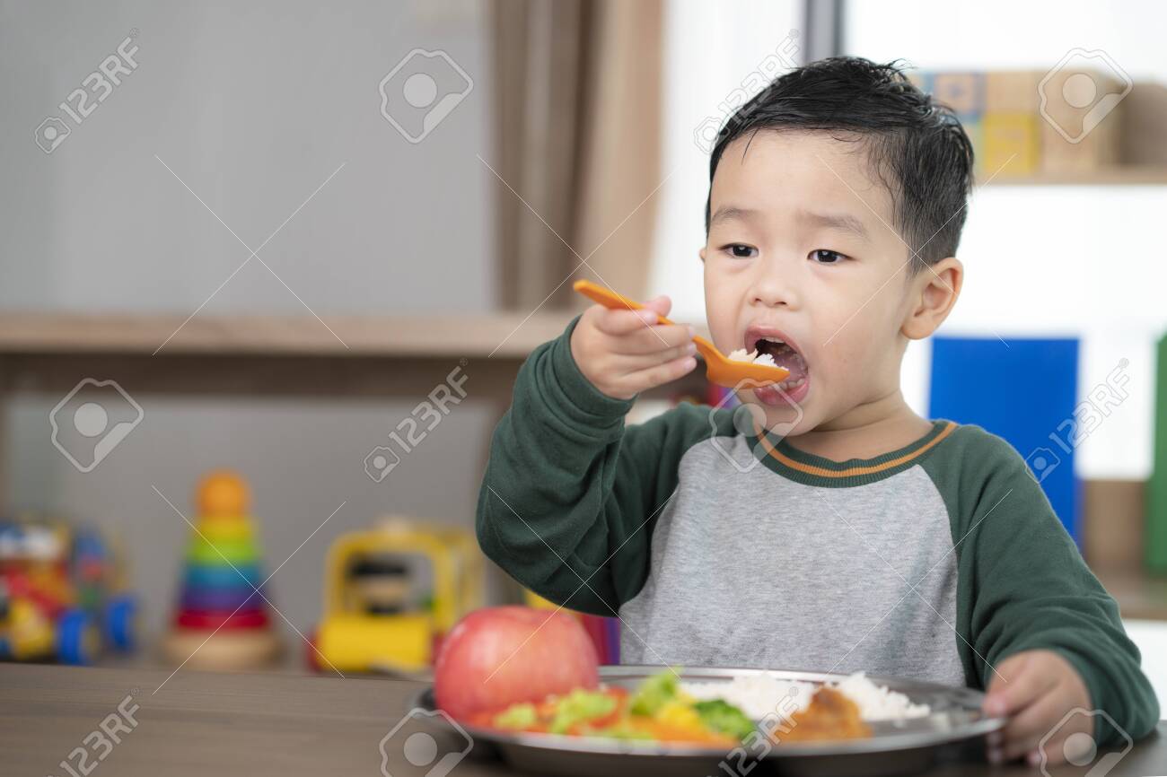 Asian student take a lunch in class room by food tray prepared by his preschool, this image can use for food, school, kid and education concept - 153803232 Asian student take a lunch in class room by food tray prepared by his preschool, this image can use for food, school, kid and education concept - 153803232