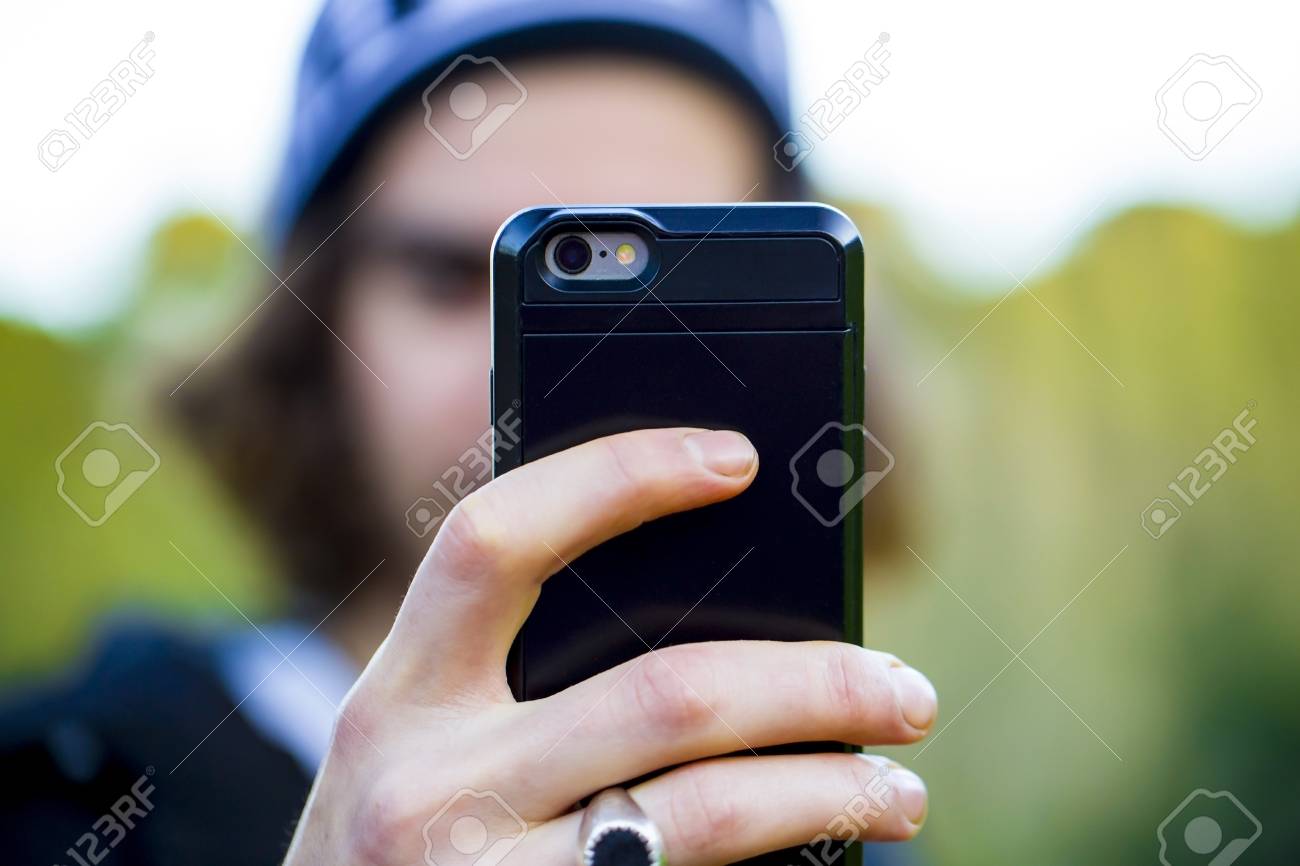 https://previews.123rf.com/images/anelik/anelik1902/anelik190200042/116786105-unrecognizable-person-taking-a-selfie-photo-with-his-smartphone-close-up-on-the-back-of-a-mobile.jpg