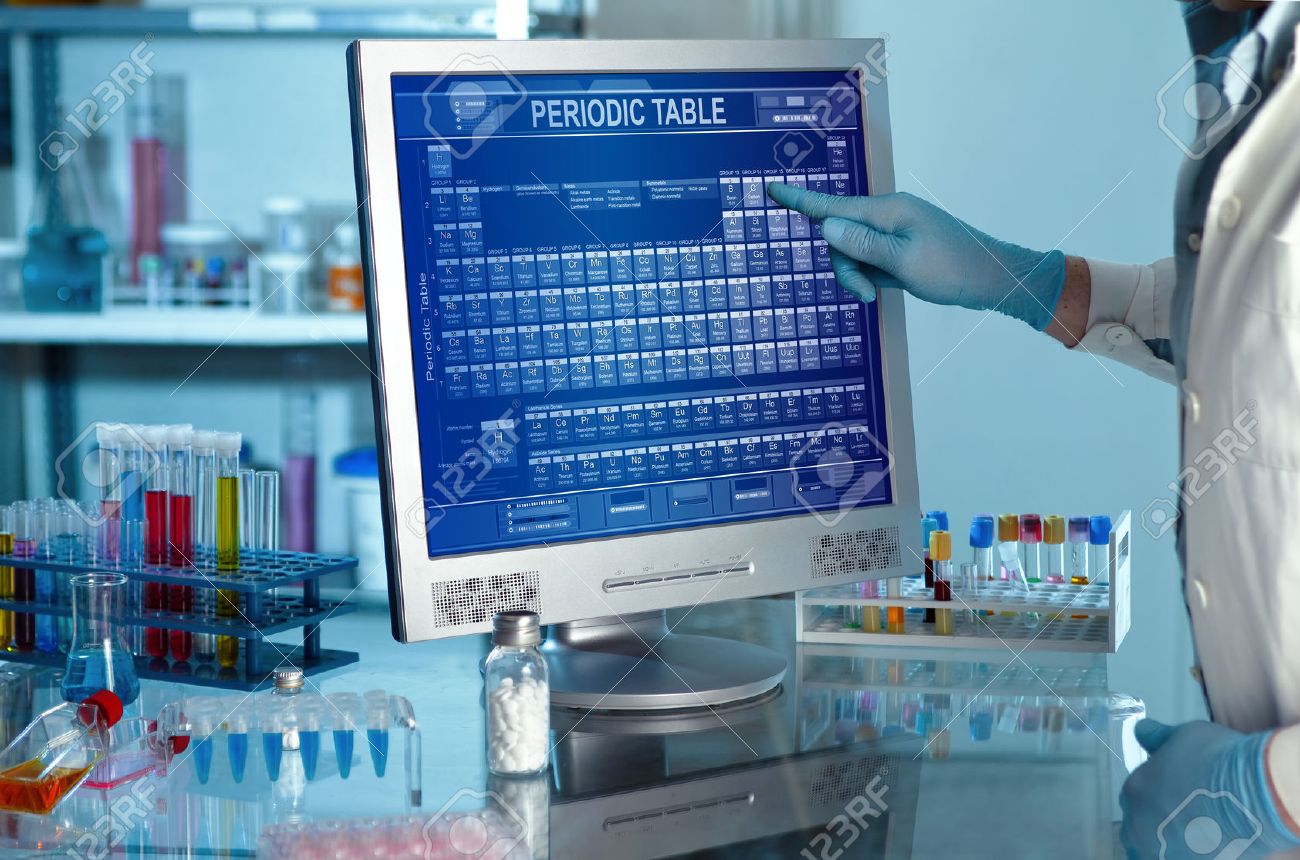 Laboratory with a researcher with periodic table on computer screen Scientific working in lab and touching a screen with the periodic table - 51327614 Laboratory with a researcher with periodic table on computer screen Scientific working in lab and touching a screen with the periodic table - 51327614