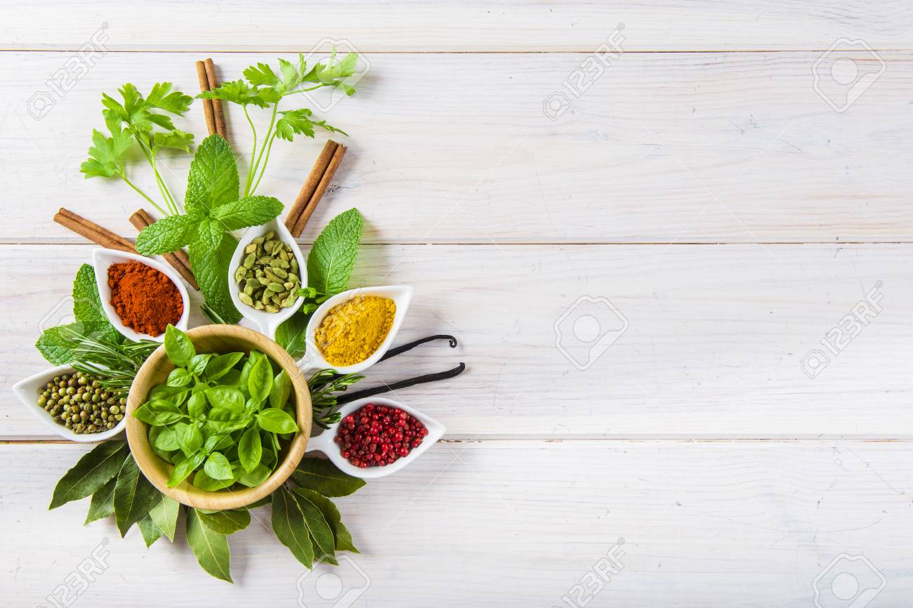 Fresh and colorful herbs and spices assortment on a white wooden background - 71881856 Fresh and colorful herbs and spices assortment on a white wooden background - 71881856