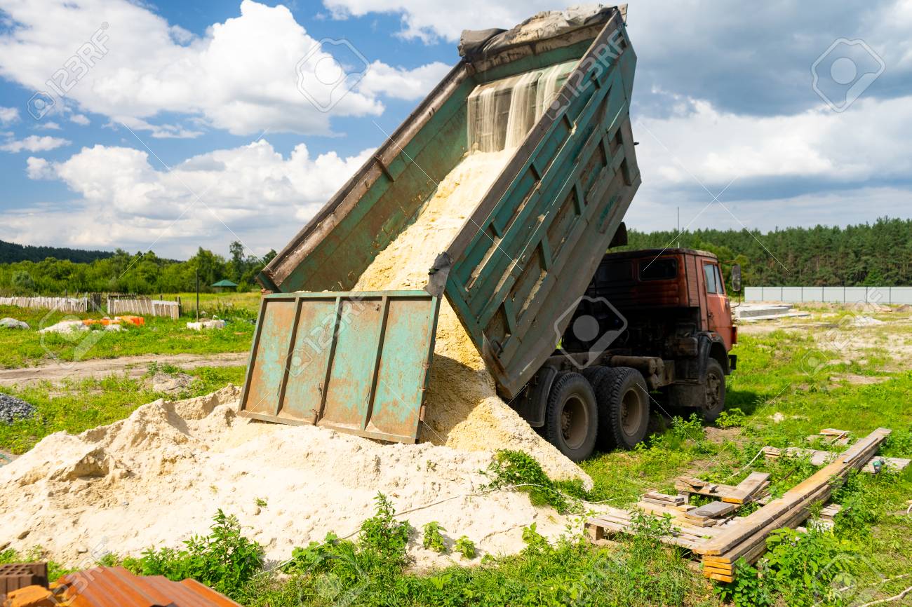 The Dump Truck Unloads Sand The Truck Dumped The Cargo Sand Stock Photo Picture And Royalty Free Image Image 109094717