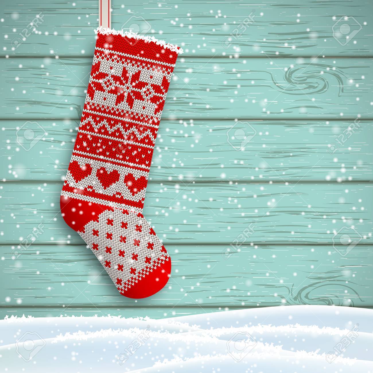 Knitted Christmas Stocking With Red Patterns On Blue Wooden Background Knitted Christmas Stocking With Red Patterns On Blue Wooden Background