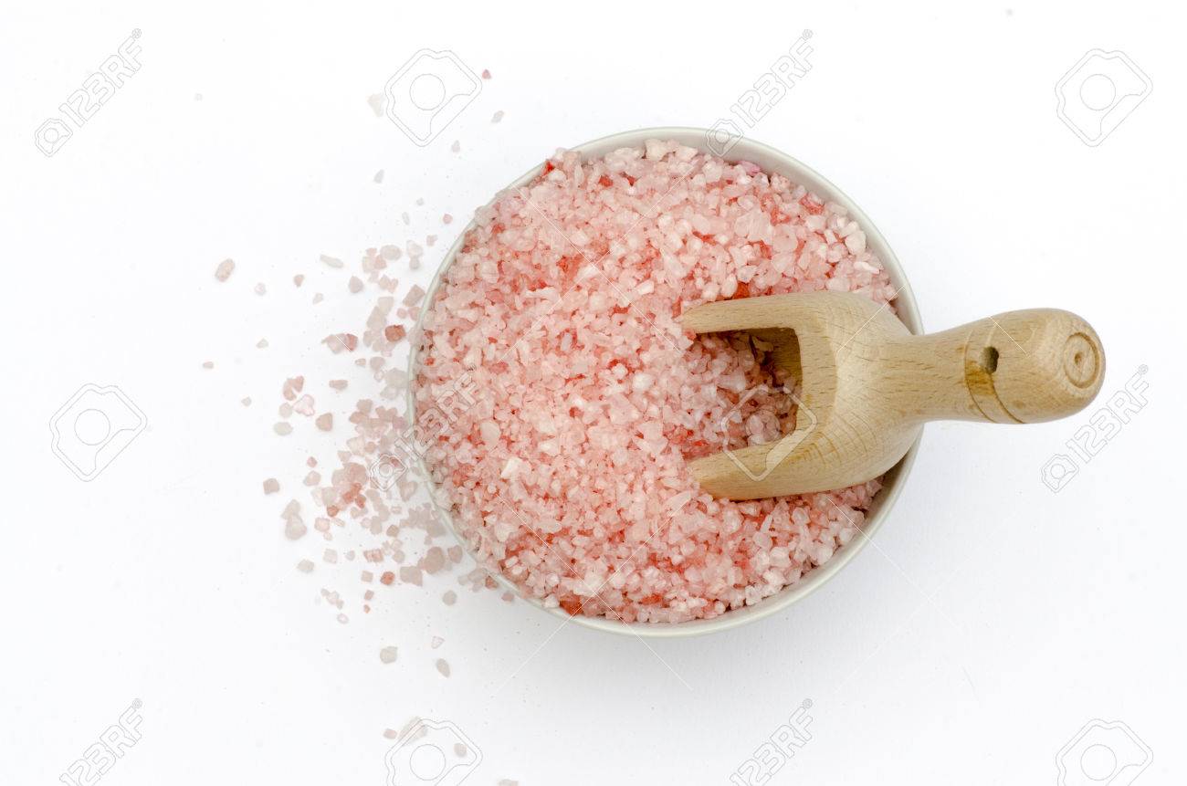 bowl full of bath salts with pink and white grains, spoon to measure, grains of salt fallen, all isolated on white background - 34090407 bowl full of bath salts with pink and white grains, spoon to measure, grains of salt fallen, all isolated on white background - 34090407