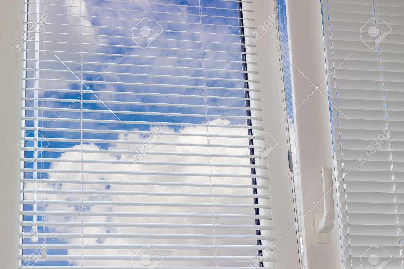 plastic window blinds horizontal fragment of the modern plastic window with venetian blinds and view sky clouds of the modern plastic window with blinds and plastic window blinds horizontal fragment of the modern plastic window with venetian blinds and view sky clouds of the modern plastic window with blinds and