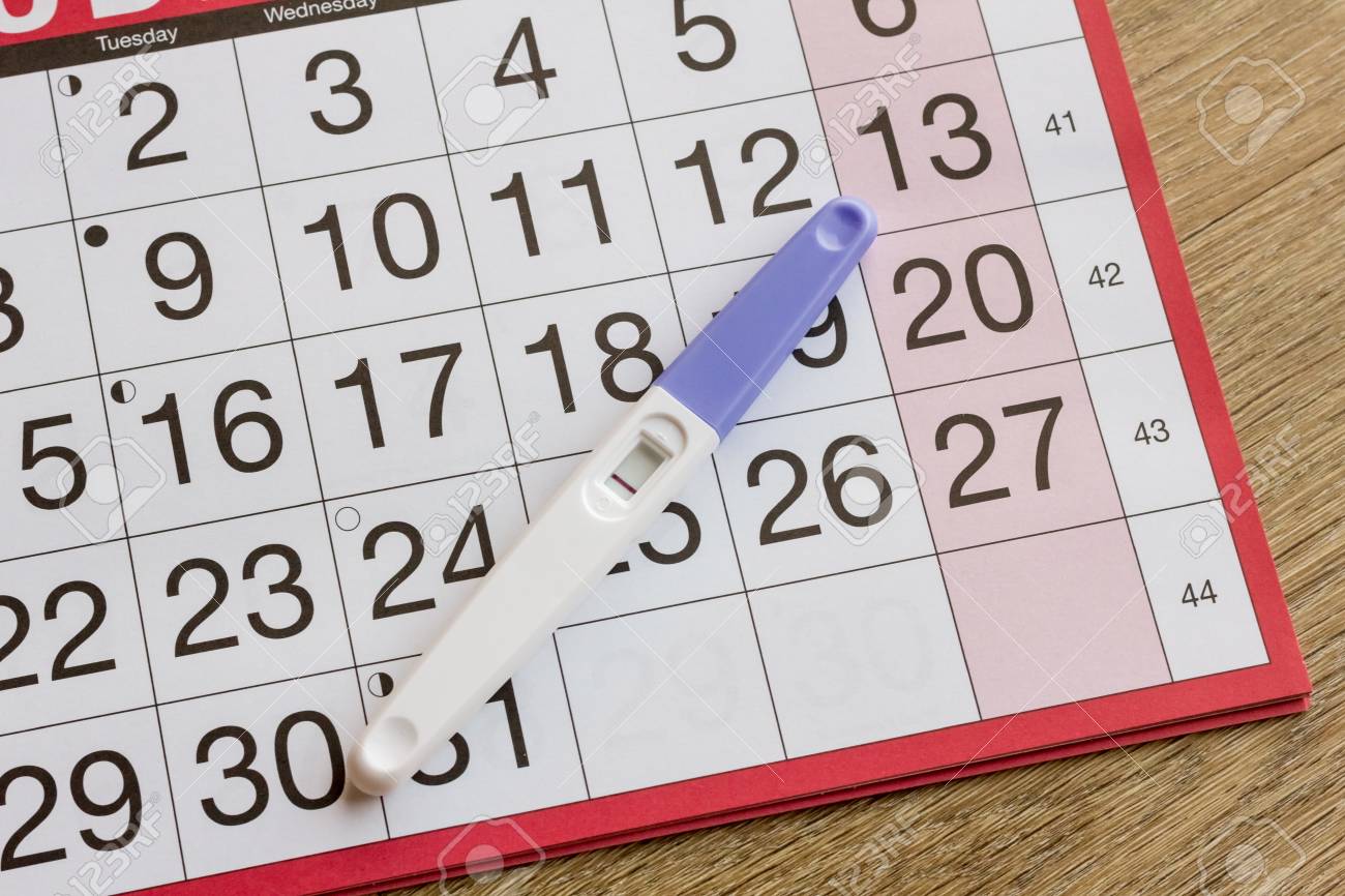 negative pregnancy test on top of calendar dates stock photo pregnancy dates calender