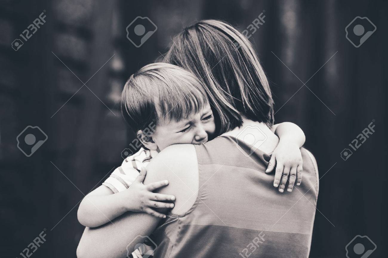 Black and white portrait of young Caucasian woman mother comforting her crying little toddler boy son outside in park on summer day, parenthood lifestyle concept - 64549777 Black and white portrait of young Caucasian woman mother comforting her crying little toddler boy son outside in park on summer day, parenthood lifestyle concept - 64549777
