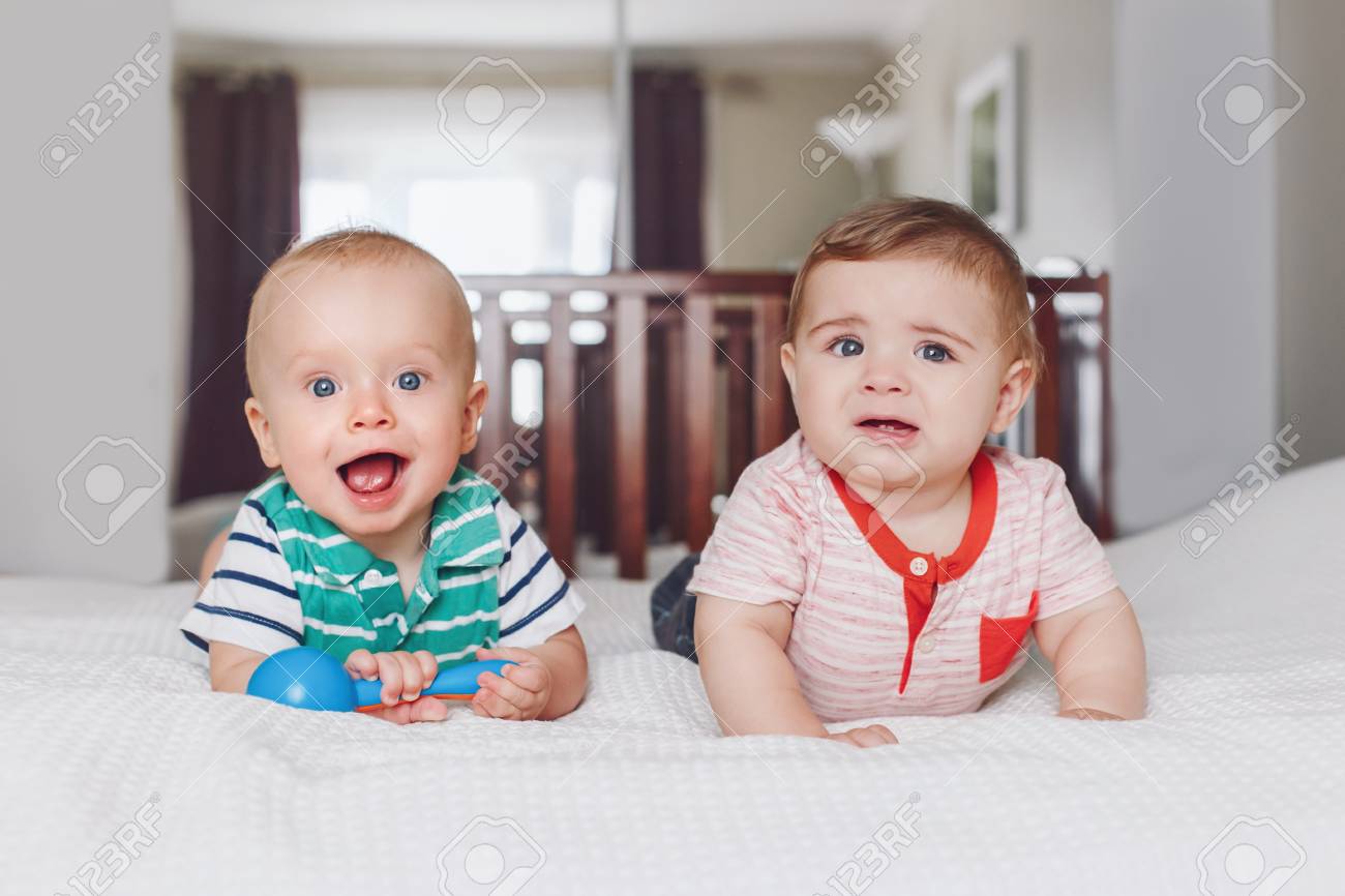 Group Portrait Of Two White Caucasian Cute Adorable Funny Baby
