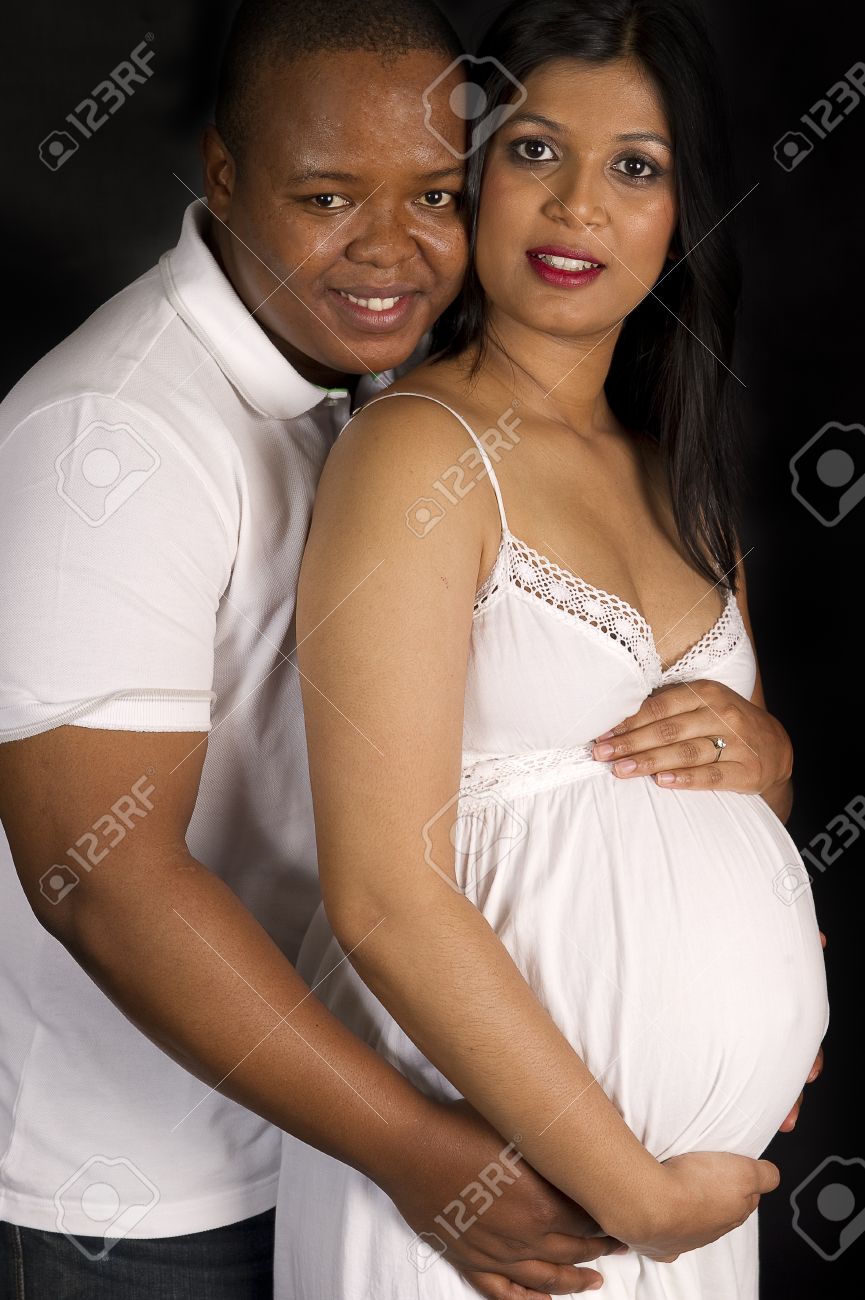 Sexy Beautiful Pregnant Indian Woman And African Male Embracing In White  Dress Smiling On Black Backdrop Stock Photo, Picture and Royalty Free  Image. Image 8725541.