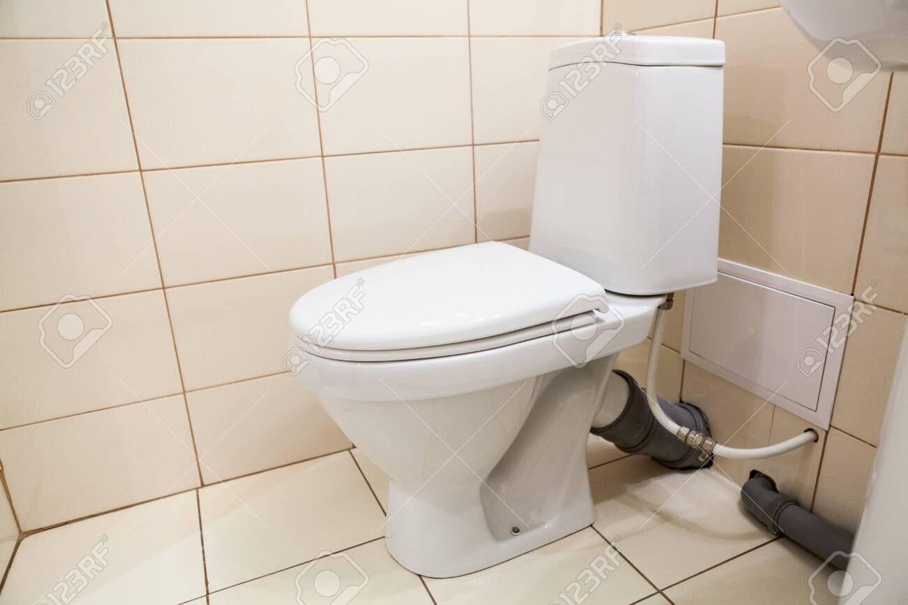 Clean White Bathroom Toilet With The Lid Closed, Side View Stock Photo,  Picture and Royalty Free Image. Image 140949553., image size:1300x866