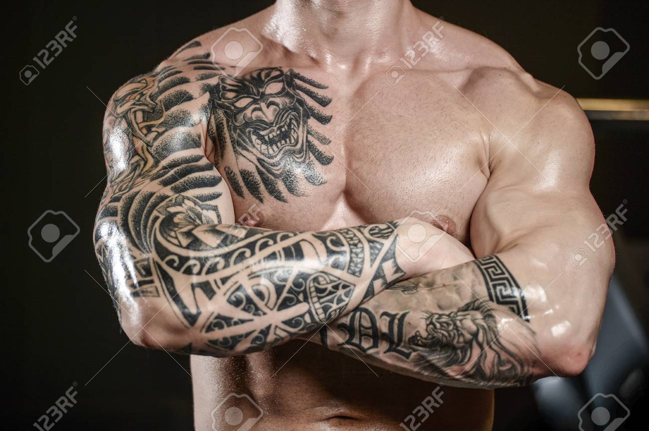 Strong And Handsome Athletic Young Tattoo Man With Muscles . Close-up Of A  Power Man On Diet Abs And Biceps Fitness And Bodybuilding Concept Stock  Photo, Picture and Royalty Free Image. Image, image size:1300x865