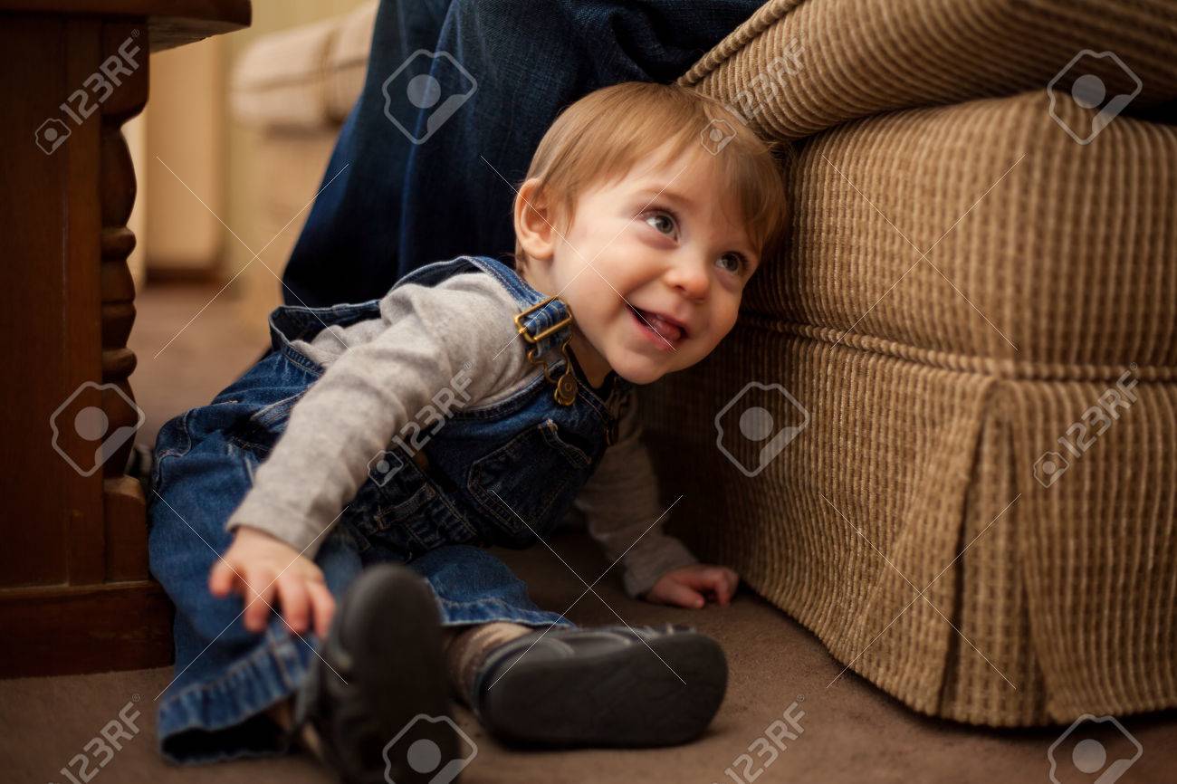 Cute Baby Boy Wearing Overalls Sitting Next To His Dad And Smiling