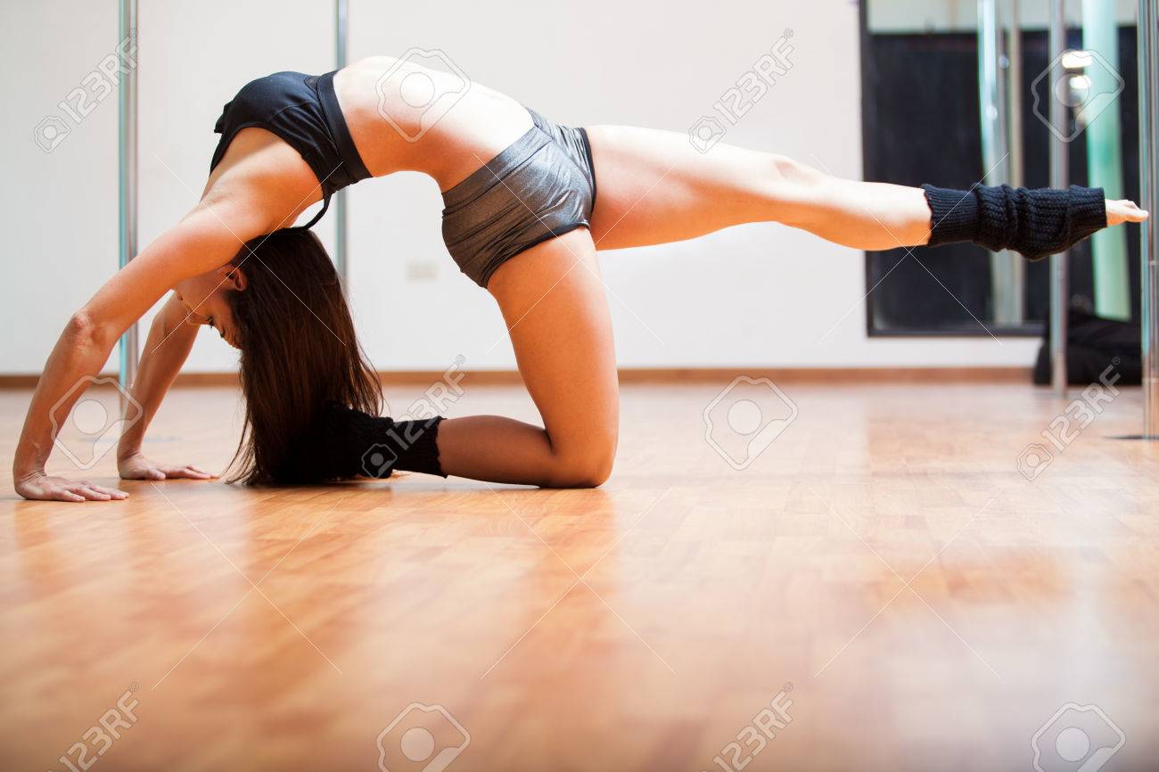 Sexy Young And Flexible Brunette Stretching And Warming Up On The Floor In A Pole Fitness Sexy Young And Flexible Brunette Stretching And Warming Up On The Floor In A Pole Fitness