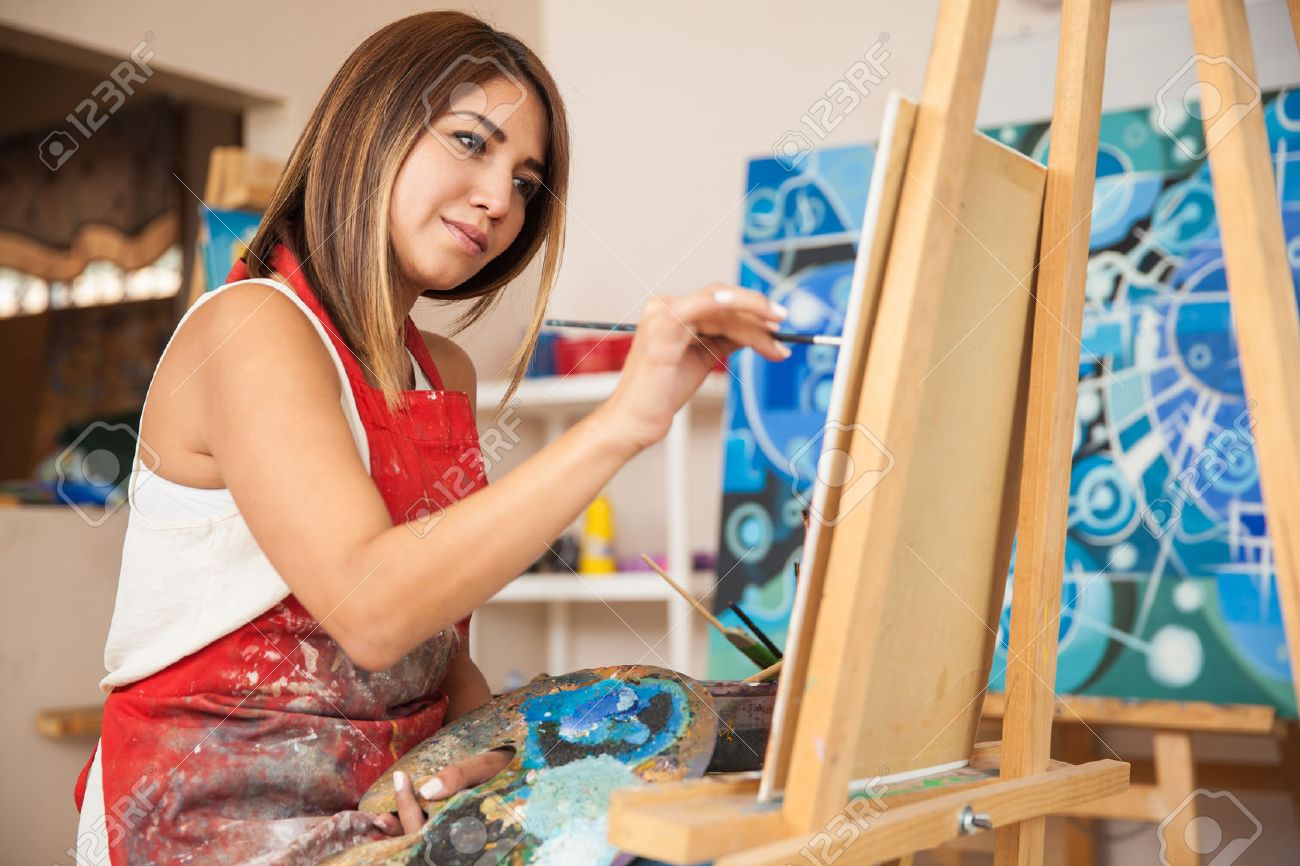 Focused Young Female Artist Working On A New Painting In Her ...