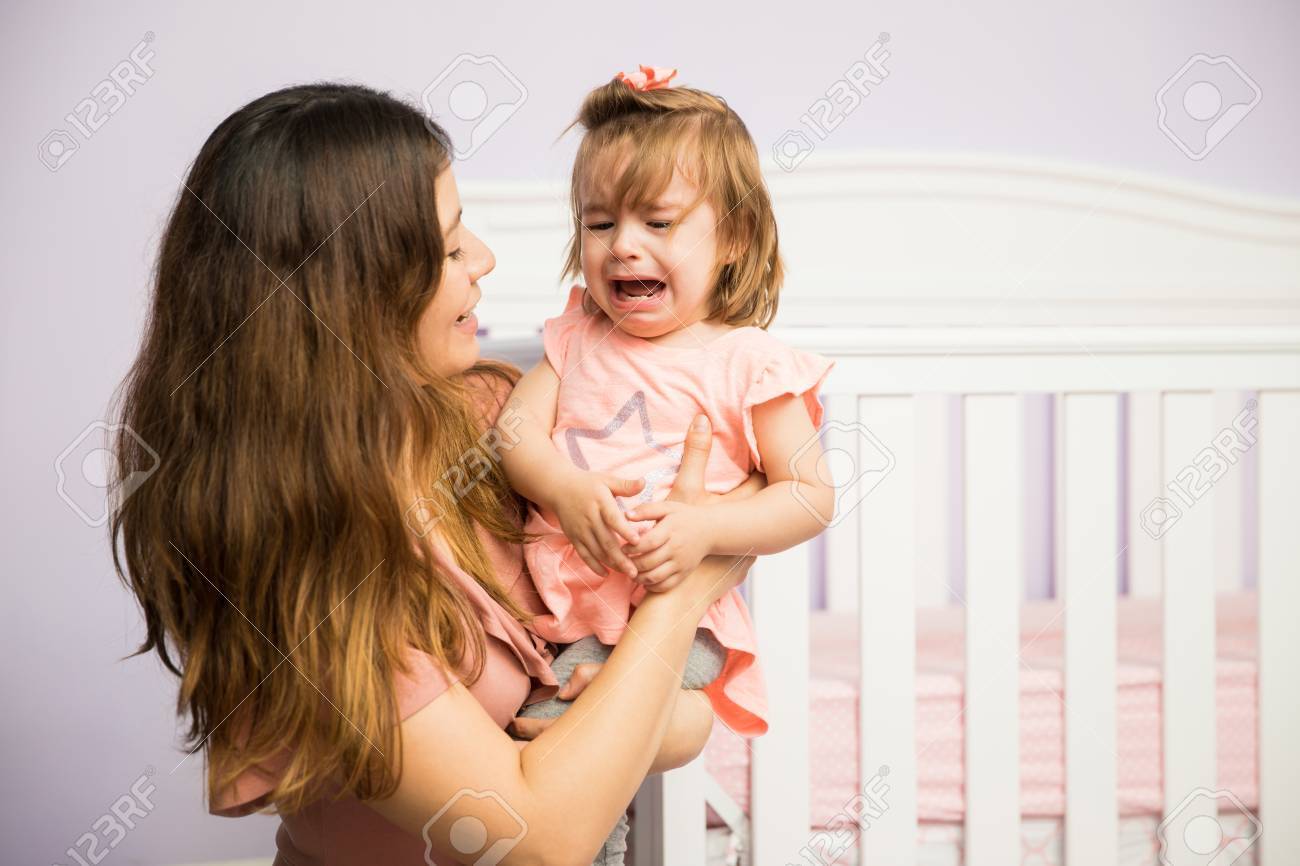 Gorgeous Hispanic Woman Trying To Make Her Angry Child Stop Crying In The  Nursery Stock Photo, Picture and Royalty Free Image. Image 75329957., image size:1300x866
