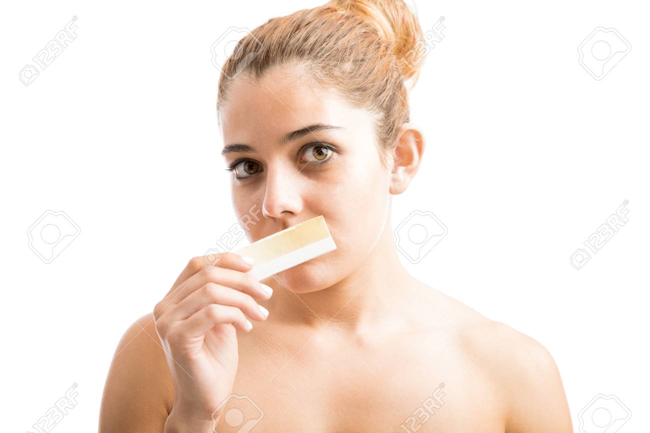 Attractive Young Woman Holding A Wax Strip For Facial Hair Removal