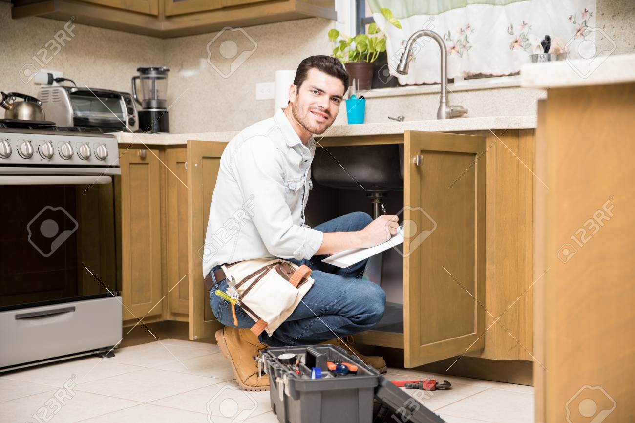portrait of an attractive hispanic handyman writing a work estimate work estimate