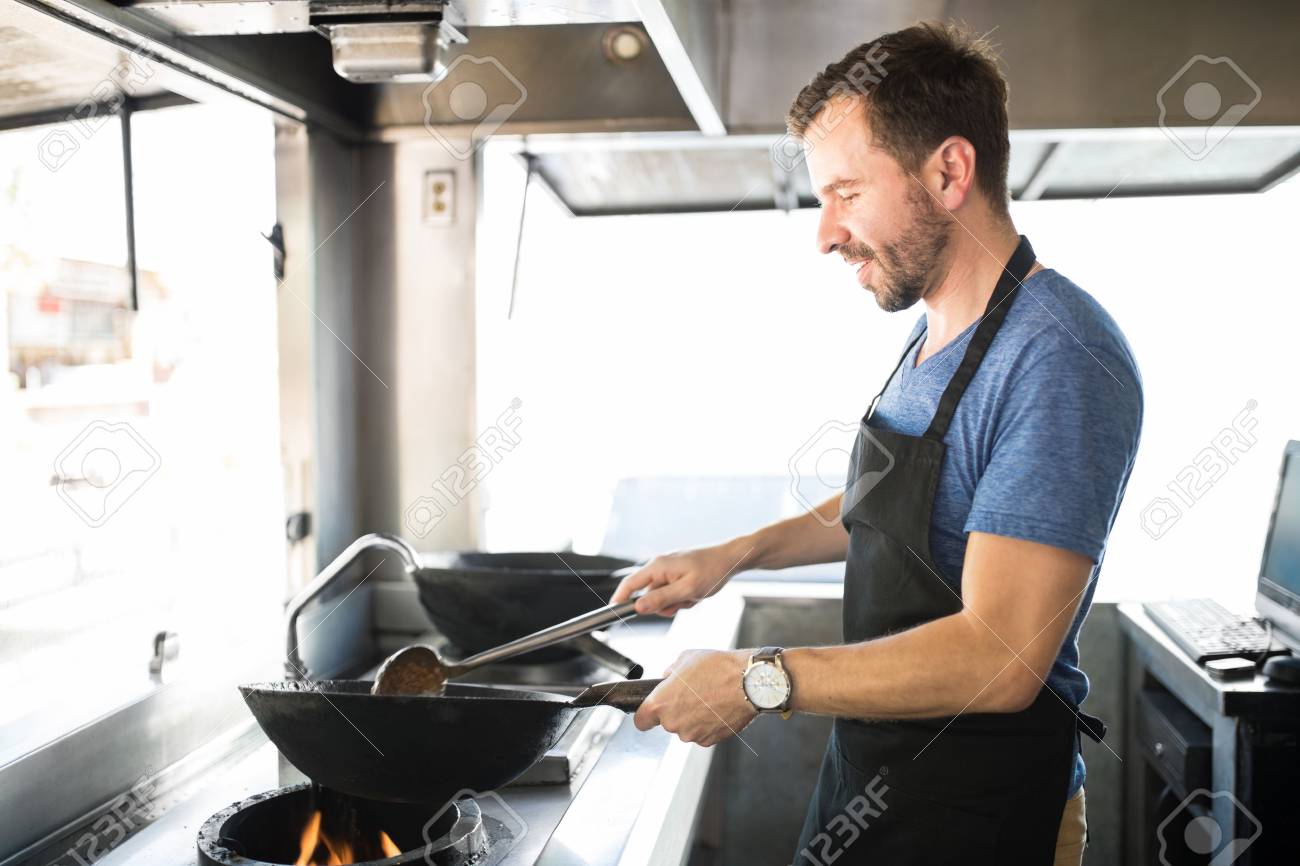Portrait Of A Good Looking Young Chef Cooking Some His Favorite Dishes In Food