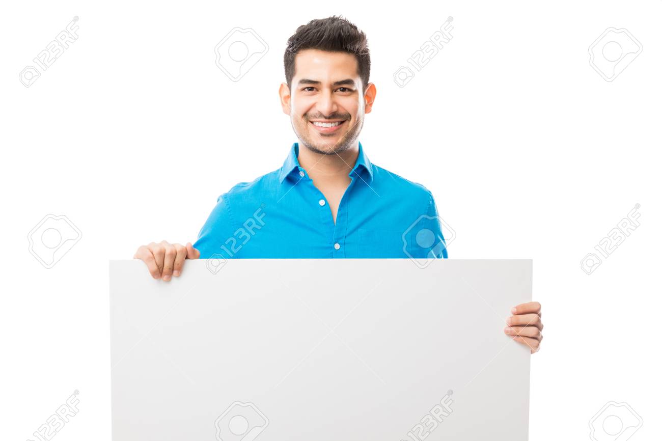 Portrait Of Attractive Male Smiling While Holding Blank Poster