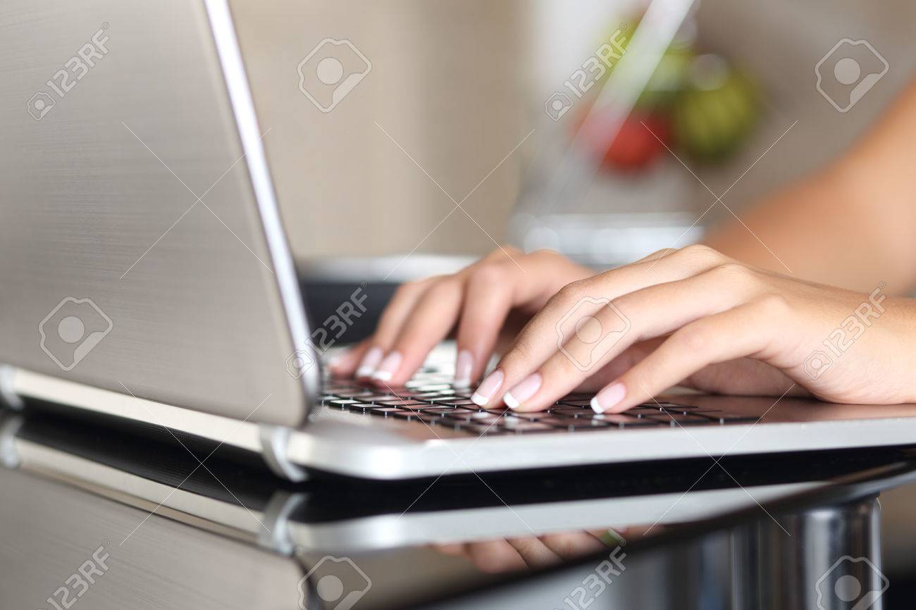 Close up of a woman hands working with a laptop at home - 34114106 Close up of a woman hands working with a laptop at home - 34114106